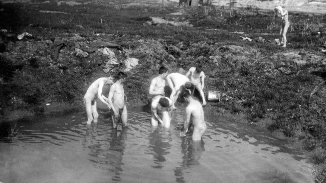 Australian servicemen bathe in shell holes after the fight for Bullecourt. Picture: Australian War Memorial (E03925)