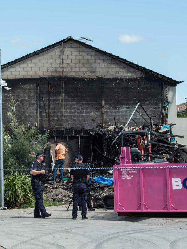 Investigators comb through the fire ruins by shovel and hand where two bodies where found overnight in Browns Plains. PICTURE: Brad Fleet