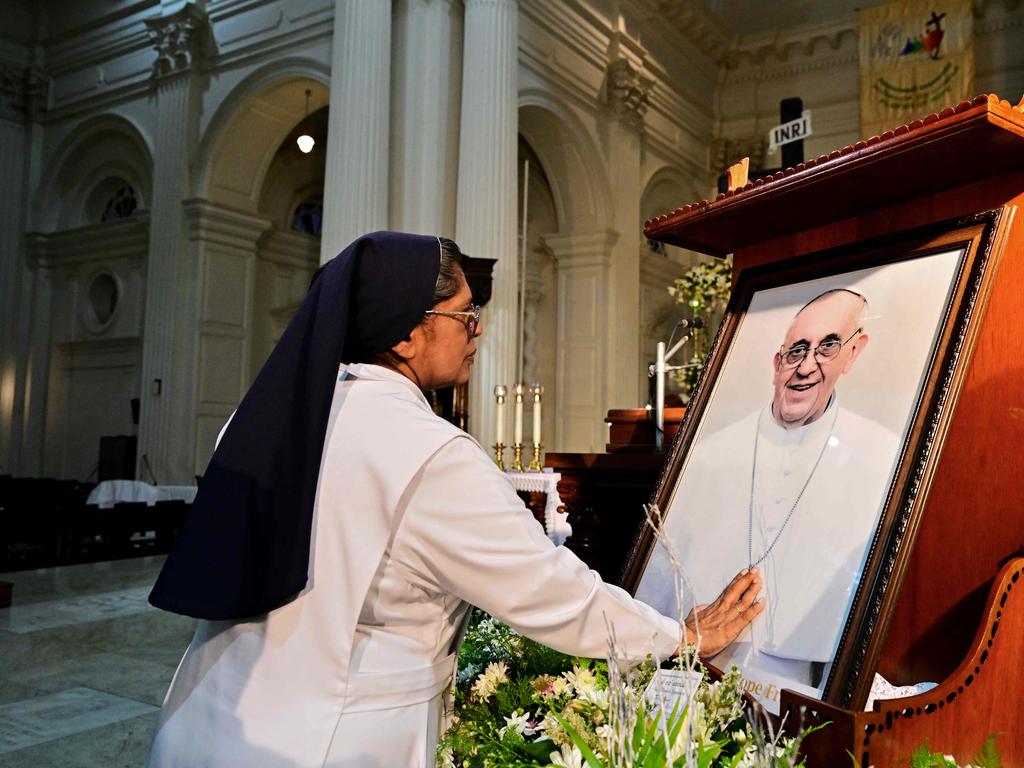 A Catholic sister touches a portrait of late Pope Francis during a holy mass held in his honour, at the Cathedral of St. Lucia in Colombo. Picture: AFP