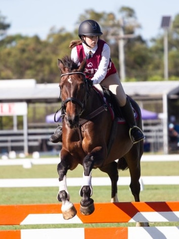 Kellie Harrison clears the planks at the 2023 PQC State Showjumping Championships.