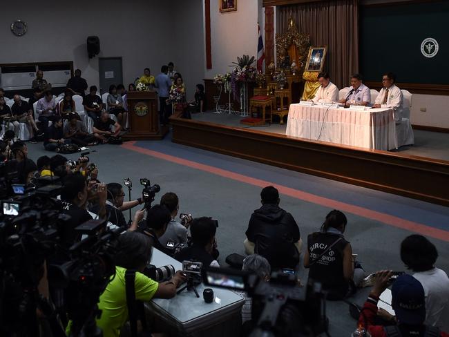 Thai health offficials Thongchai Lertwilairattanapong (l), Dr Jesada Chokedamrongsuk (c) and Dr Chaiwet Thanapaisan (r) brief the media about the condition of the eight boys in hospital. Picture: AFP/Lillian Suwanrumpha