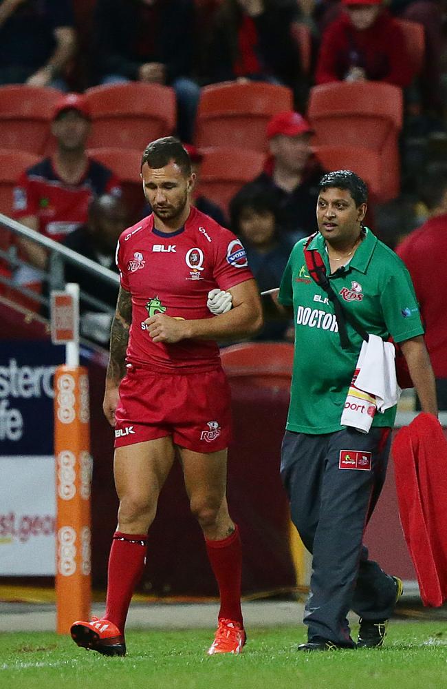 Quade Cooper leaves the field after injuring his collarbone at Suncorp Stadium. Picture: Peter Wallis