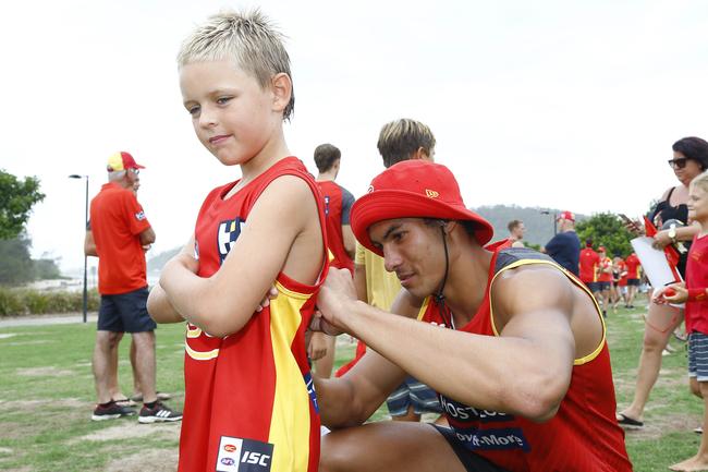 Gold Coast Suns player Patrick Murtagh with a fan at Palm Beach. Picture: Tertius Pickard