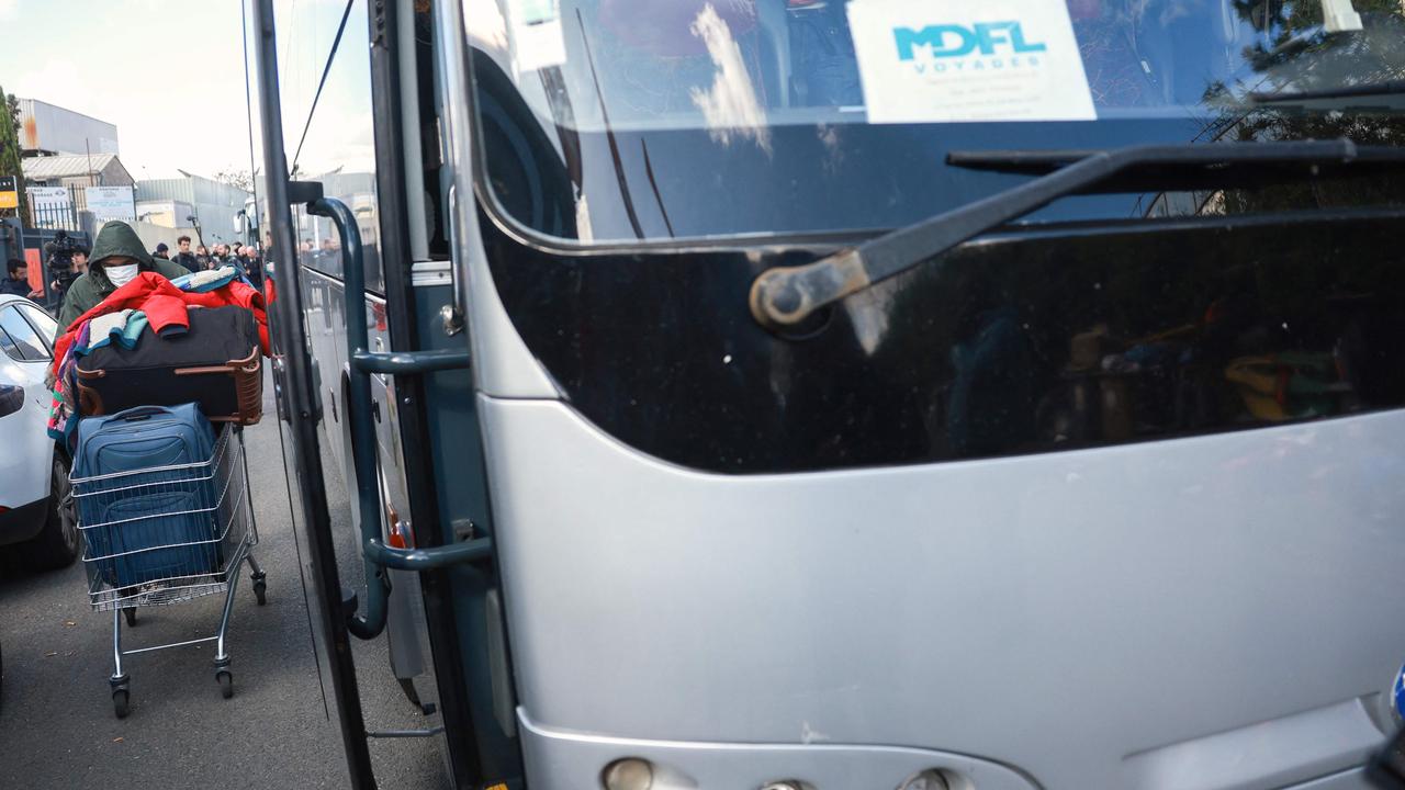 A bus waiting for migrants to be taken to the Val-de-Loire migrants reception centre, during the evacuation of France's biggest squat on April 17, 100 days before the Olympic Games. Picture: Emmanuel Dunand / AFP