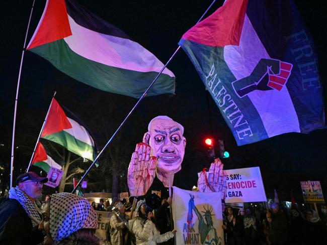 Activists wave Palestinian flags near a large effigy of Israeli Prime Minister Benjamin Netanyahu as they rally in support of Palestinians near the White House. Picture: AFP