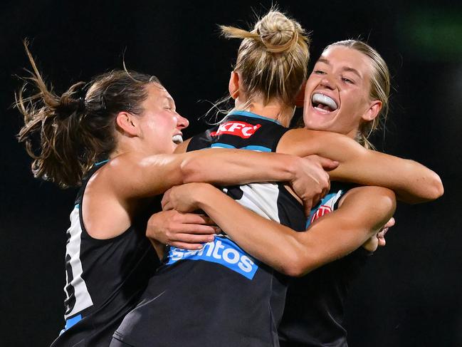 MELBOURNE, AUSTRALIA - NOVEMBER 16: Ashleigh Saint,  Ella Boag and Kirsty Lamb of the Power celebrate winning the AFLW Semi Final match between Hawthorn Hawks and Port Adelaide at Ikon Park, on November 16, 2024, in Melbourne, Australia. (Photo by Quinn Rooney/Getty Images)