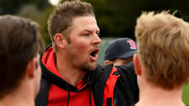 Romsey coach Justin Sherman talks to his players. Picture: Josh Chadwick