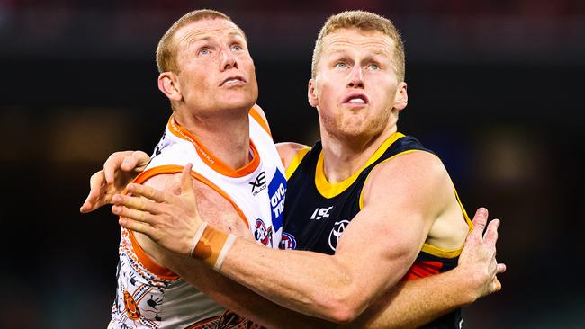 Reilly O’Brien, pictured rucking against his predecessor Sam Jacobs, has become the second least experienced player to win the Crows’ best-and-fairest. Picture: Sarah Reed