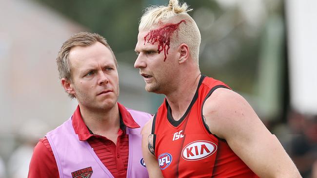 Jake Stringer is helped from the field after a head knock. Picture: Michael Klein