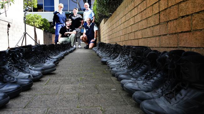 Top Row; Sergeant Cindy Larsson, Sharnie Meyer (Mission Australia), Superintendent Allan Sicard, Glenn Garlick (Mission Australia) and Senior Constable Paul Waite with some of the boots collected from Harbourside LAC.