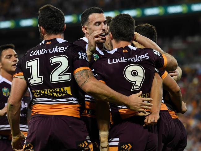 Brisbane Broncos players celebrate a try.