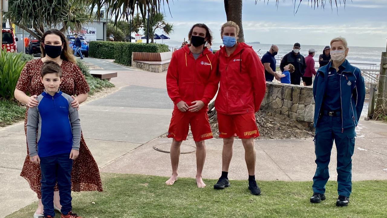 Melbourne mother Fiona MacDonald and her son 8-year-old Hamish King reunite with rescuers Jake Simpson and Zac Turner as well as Queensland Ambulance Service senior operations supervisor Danielle Williams after being caught in a flash rip on the Sunshine Coast.