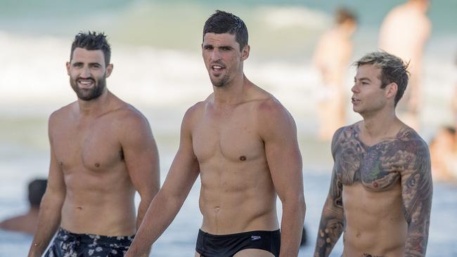 Pies Alex Fasolo, Scott Pendlebury and Jamie Elliott cool off at Kurrawa Beach on the Gold Coast on Friday afternoon. Picture: Jerad Williams