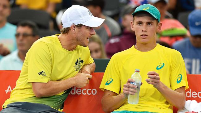 Team captain Lleyton Hewitt talks tactics with Alex de Minaur during a Davis Cup match in February 2018. Picture: Bradley Kanaris/Getty Images