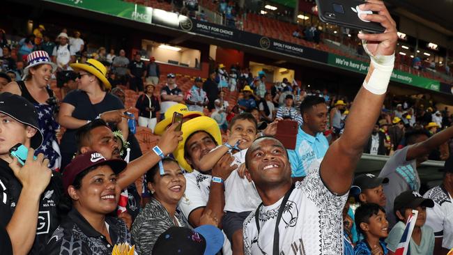 Fiji's Alosio Naduva celebrates with fans after winning the final of the World Rugby Sevens Series in Hamilton. Plenty of tickets have already been snapped for the Sydney Sevens Picture: AFP