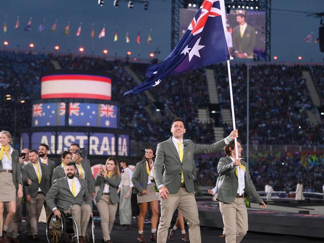 BIRMINGHAM, ENGLAND - JULY 28: Eddie Ockenden and Rachael Grinham, Flag Bearers of Team Australia lead their team out during the Opening Ceremony of the Birmingham 2022 Commonwealth Games at Alexander Stadium on July 28, 2022 on the Birmingham, England. (Photo by David Ramos/Getty Images)