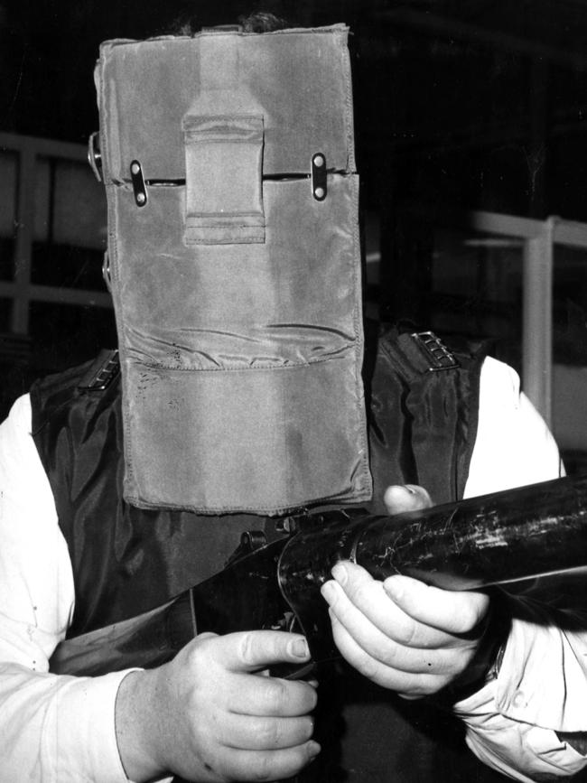 1968: Reporter Alan Dearn poses for <i>The Herald</i> in a bizarre new design of Victorian police armour, which resembled Ned Kelly’s famous helmet. It was said to be able to stop a .32 bullet from three metres, but the design never took off, and was abandoned after trials.