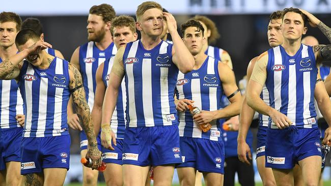 Jack Ziebell leads North Melbourne off after a loss.