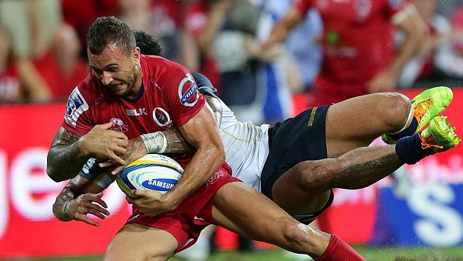 Quade Cooper of the Reds loses the ball over the try line in the tackle of Joe Tomane of the Brumbies during the Super Rugby match between the Queensland Reds and the Brumbies. Pic Darren England.