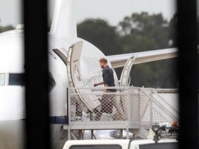 Prince Harry boarding a plane at Sydney Airport this morning to fly to Hervey Bay Airport. Picture: David Swift