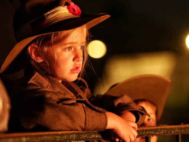 A child at the Eternal Flame at the Shrine of Remembrance at the ANZAC Day dawn service in Melbourne. Picture: Hamish Blair