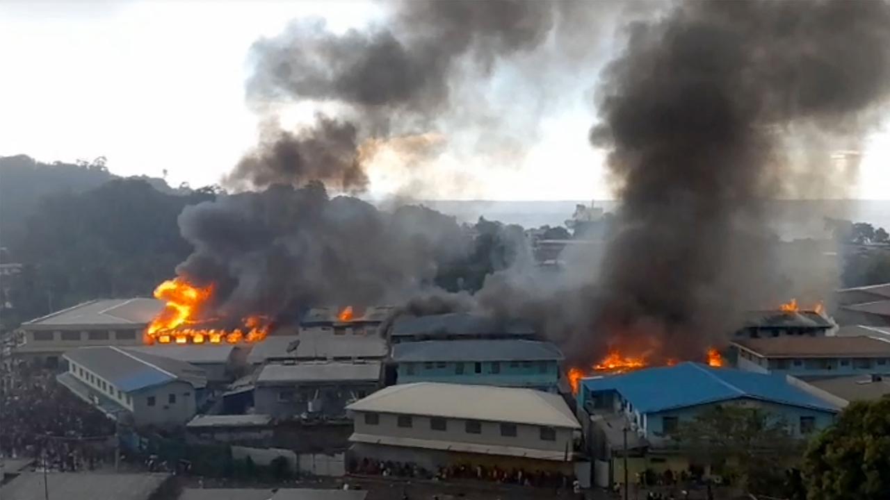 Parts of the Chinatown district on fire in Honiara, as rioters torched buildings in the capital in a second day of anti-government protests. Picture: JOB RONGO'AU FUOO / ZFM Radio / AFP