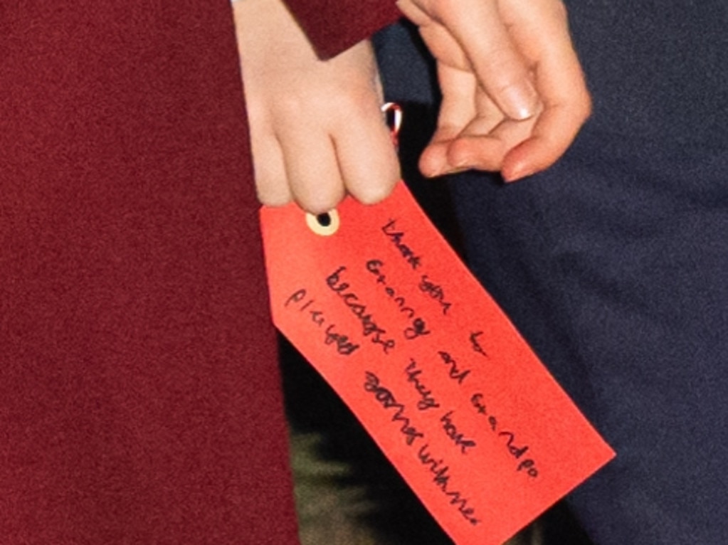 Prince Louis of Wales holds a hand written note addressed to his grandparents as he attends the 'Together At Christmas' Carol Service at Westminster Abbey. Picture: Samir Hussein/WireImage