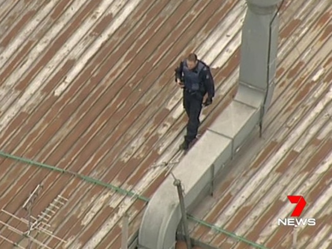 Police search for a burglar on a Melbourne CBD rooftop. Picture: Channel 7