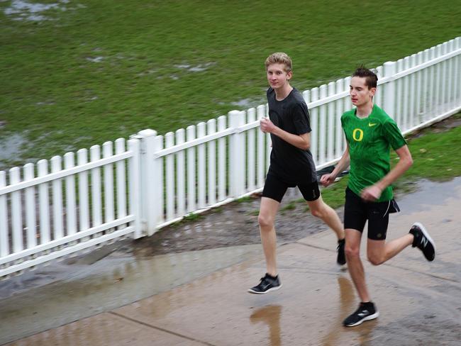 Brothers Nick and Tom Corel training in the rain in Mosman. Picture: Virginia Young