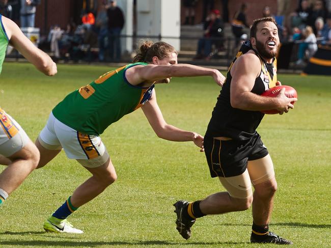 Golden Grove's Connor Dodd tries to tackle Brighton's John McPherson at Thebarton Oval in Torrensville, Saturday, Sept. 9, 2017. (AAP Image/MATT LOXTON)