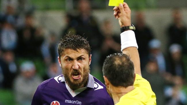 Perth Glory defender Dino Dino Djulbic cops a yellow card against Melbourne City.