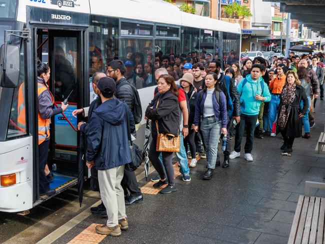 Passengers queued for hundreds of metres for buses at Lidcombe on Wednesday. Picture: Justin Lloyd.