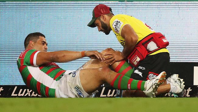 Greg Inglis is attended by medical staff after injuring his knee. Picture: Brett Costello