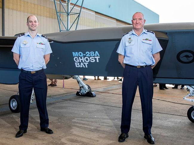 Royal Australian Air Force aviators Flight Sergeant Stephan Barchard and Corporal David Grieger (left) stand the MQ-28A Ghost Bat aircraft at RAAF Base Amberley, Queensland. Picture: Department of Defence