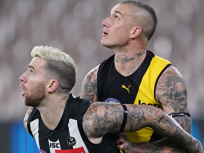 Jeremy Howe of the Magpies competes for the ball against Dustin Martin of the Tigers during the Round 2 AFL Match between the Collingwood Magpies and Richmond Tigers at the Melbourne Cricket Ground in Melbourne, Thursday, June 11, 2020. (AAP Image/Michael Dodge) NO ARCHIVING, EDITORIAL USE ONLY