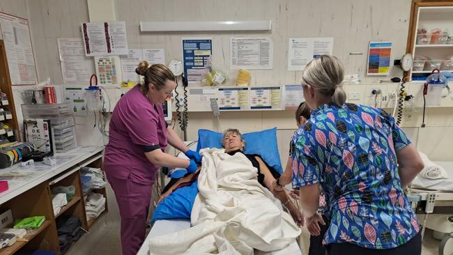 Retired nurse Pam Bennett, 68, of Minlaton, is helped out of her wetsuit at the Royal Adelaide Hospital after she was stung by a sting ray on the Yorke Peninsula