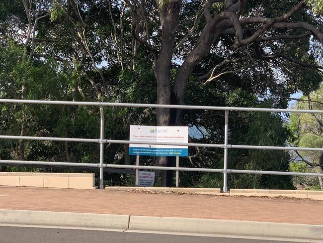 A sign indicating trees have been vandalised – but without the large, view-blocking fence.