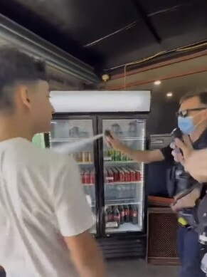 A still from footage showing St Bernards Fruit and Veg Market owner John Kapiris and his 15-year-old son being allegedly pepper sprayed by police. Picture: Facebook