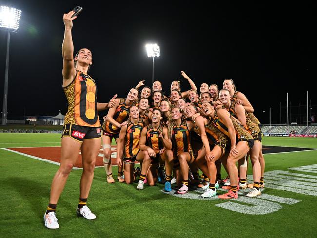 CAIRNS, AUSTRALIA - OCTOBER 24: The Hawks pose for a selfie after winning the round nine AFLW match between Hawthorn Hawks and Narrm (Melbourne Demons) at Cazaly's Stadium, on October 24, 2024, in Cairns, Australia. (Photo by Emily Barker/Getty Images)