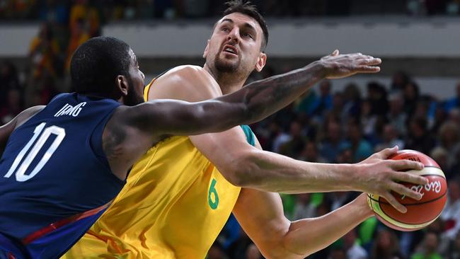 Australia's Andrew Bogut holds off USA's Kyrie Irving during their group clash.