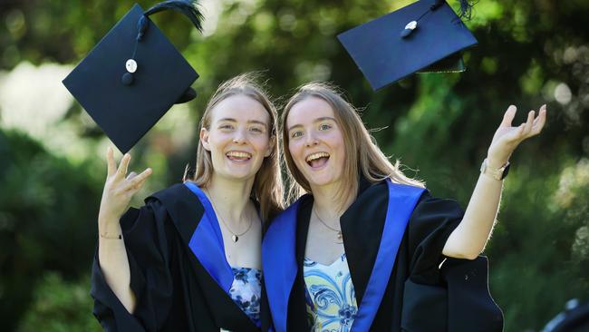 Twin sisters Erin and Maddy Menzies both graduated from Victoria University with a Bachelor of Business. Picture: David Caird