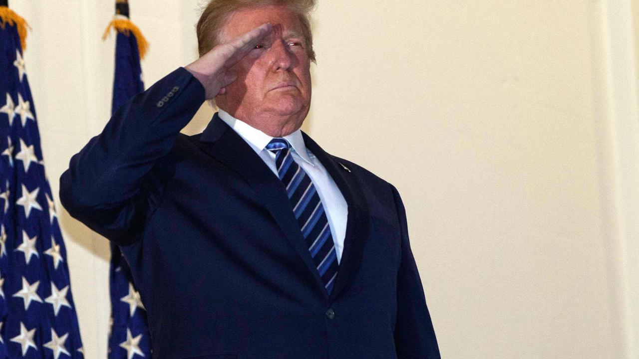 Mr Trump saluting. Picture: Nicholas Kamm/AFP