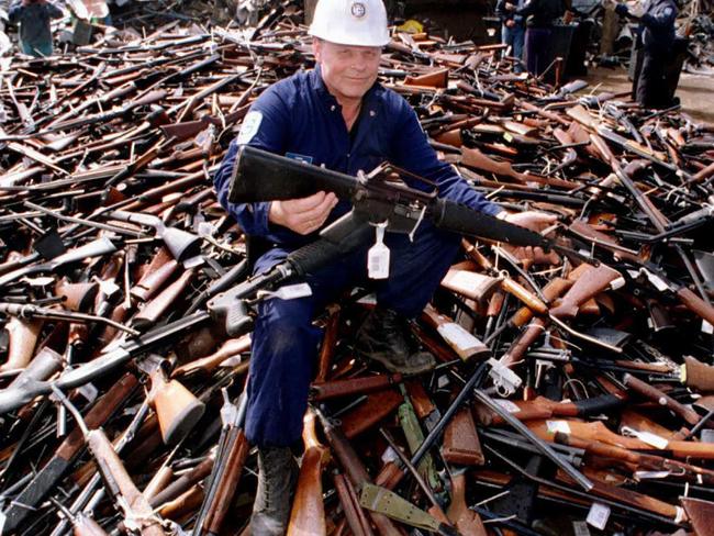 Norm Legg, a project supervisor with a local security firm, holding up an armalite rifle which is similar to the one used in the Port Arthur massacre. Picture AFP/William West