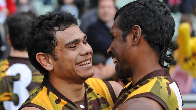 Cyril Rioli and Carl Peterson celebrate a goal while playing together.