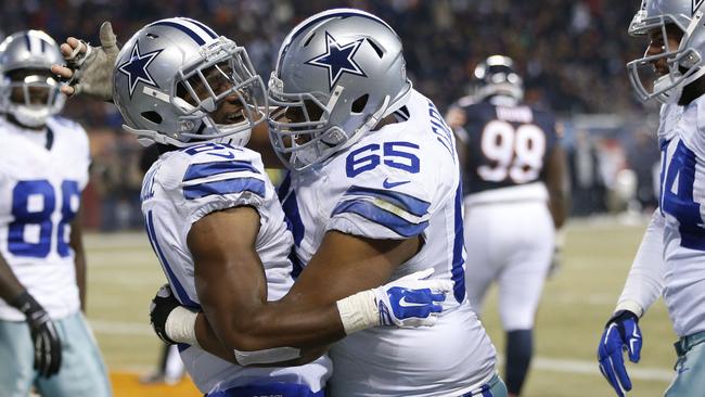 Joseph Randle #21 of the Dallas Cowboys (L) celebrates his touchdown.