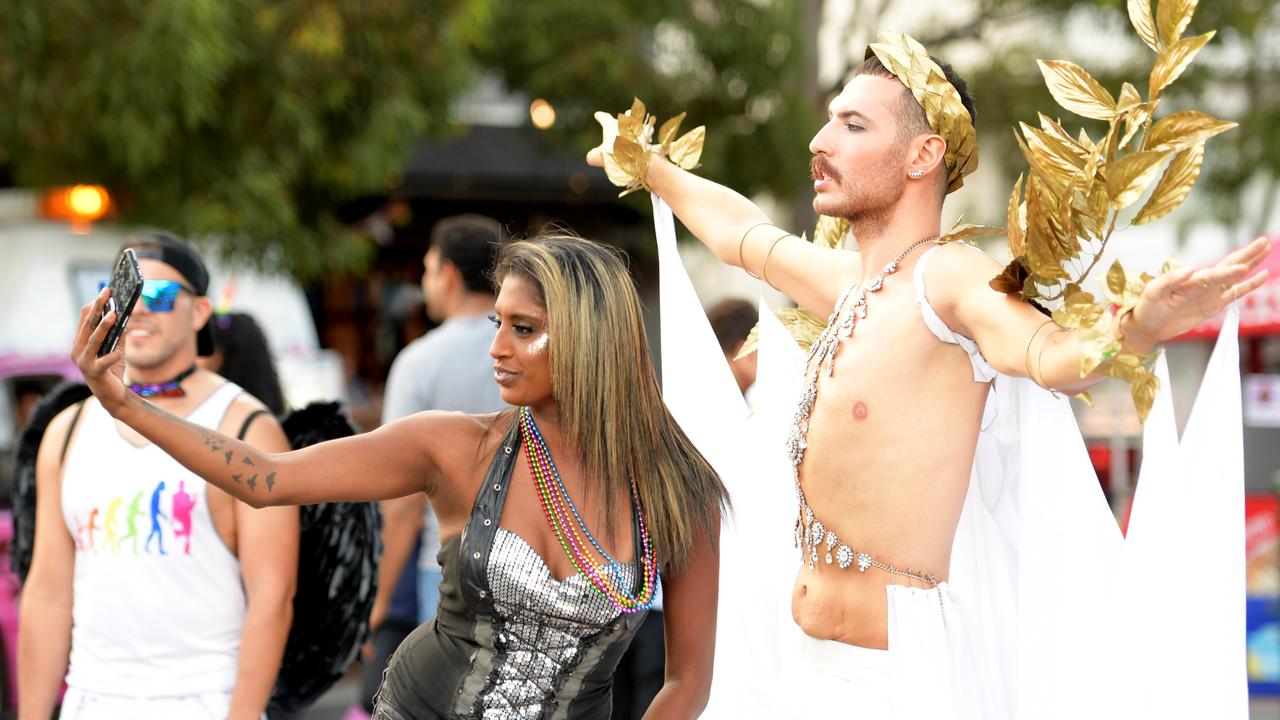 Tolga takes a selfie with a passerby in front of the Oxford Hotel. Picture: Tracey Nearmy/Sunday Telegraph