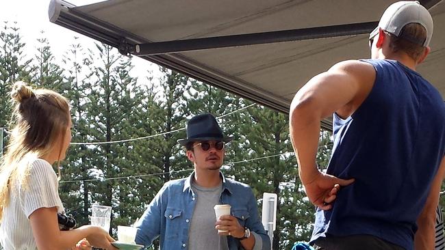 Orlando Bloom enjoying coffee at Elk Espresso with minder and personal trainer.