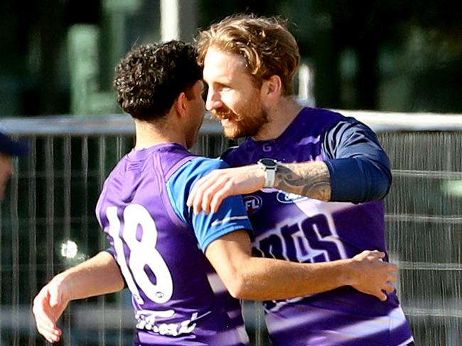 Tyson Stengle back on the training ground gets a hug from Zach Tuohy after a stint in hospital after a night out on the town. Picture: Alison Wynd