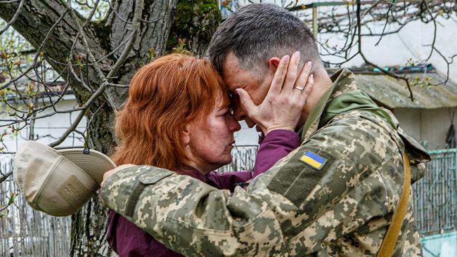 A woman farewells her serviceman husband before he departs for the frontline in Uzhhorod, Ukraine, in April last year. Picture: Reuters