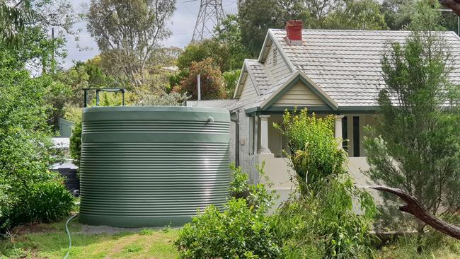 Magill resident Branko Soda wants a rainwater tank put next to his house by a neighbour moved further away. Picture: Colin James